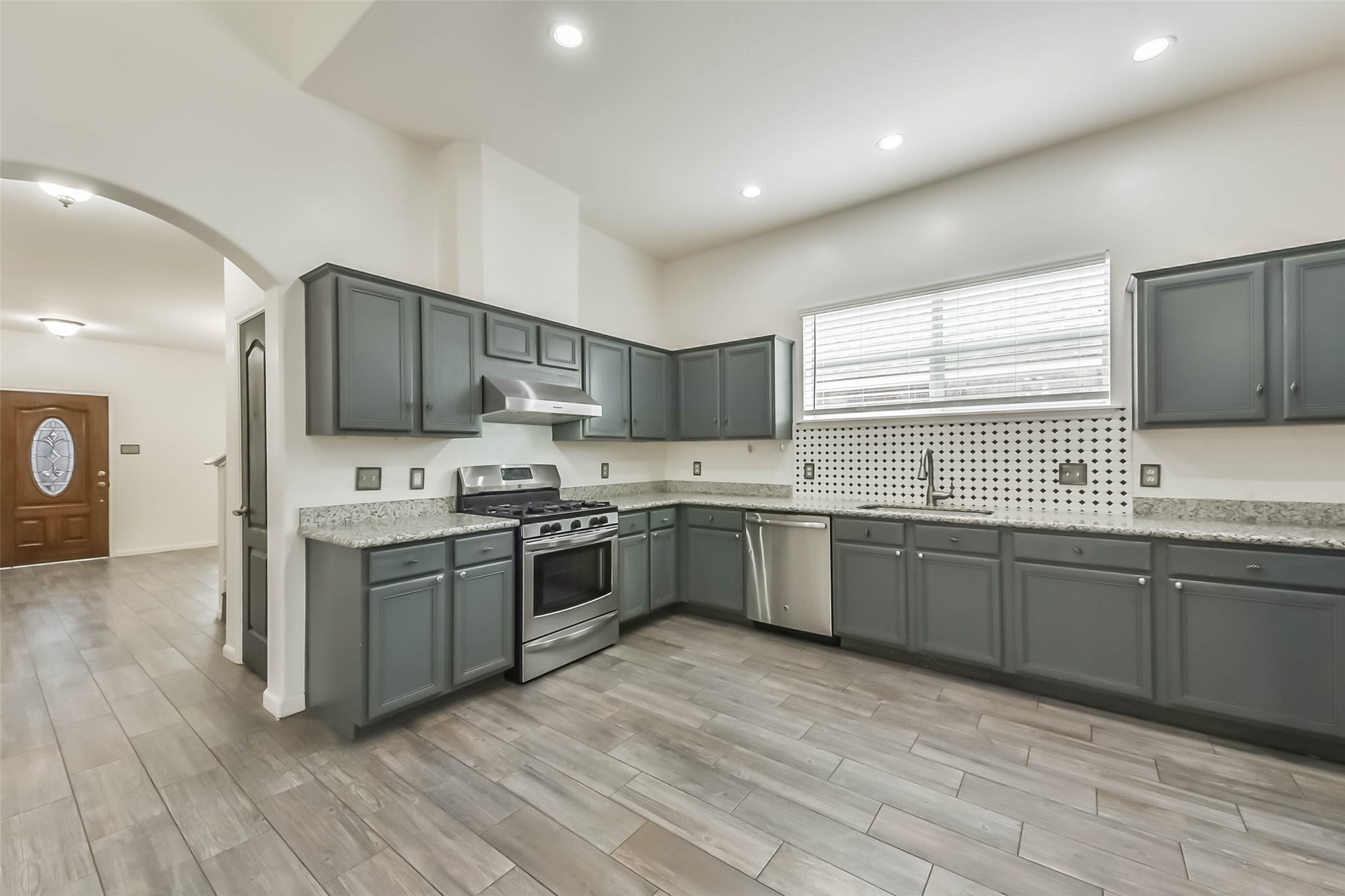10114 Sand Tracks Court Houston, TX 77064 - Photo 19 of 49 a large kitchen with stainless steel appliances lots of counter space sink and a microwave