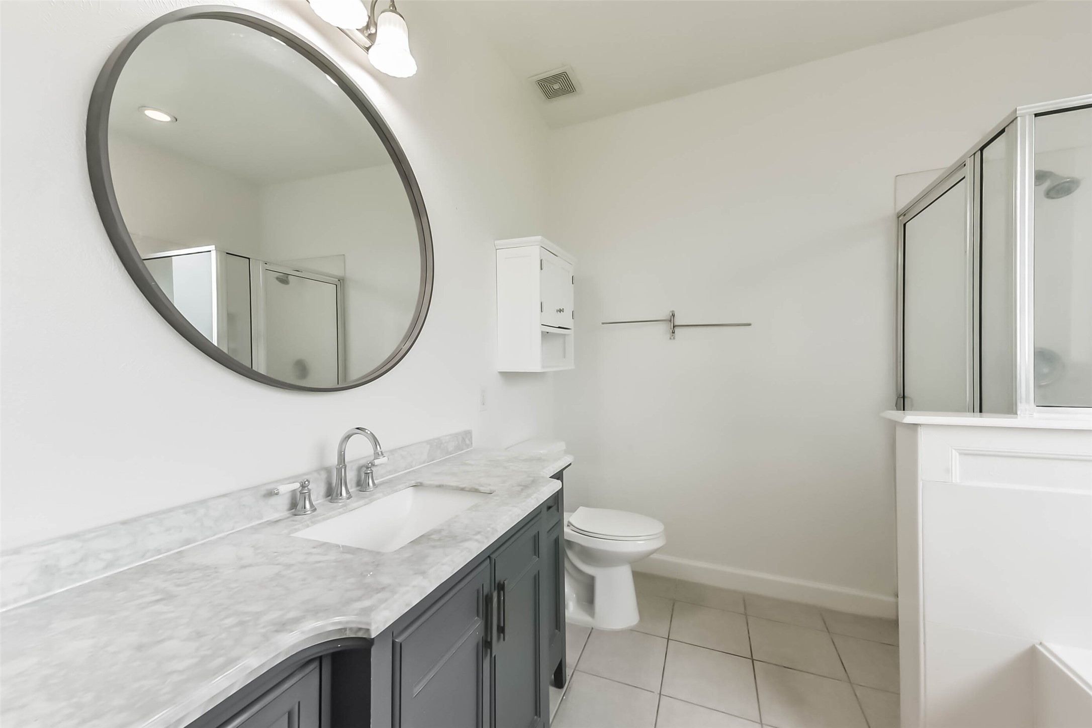 10114 Sand Tracks Court Houston, TX 77064 - Photo 26 of 49 a bathroom with a granite countertop sink and a mirror