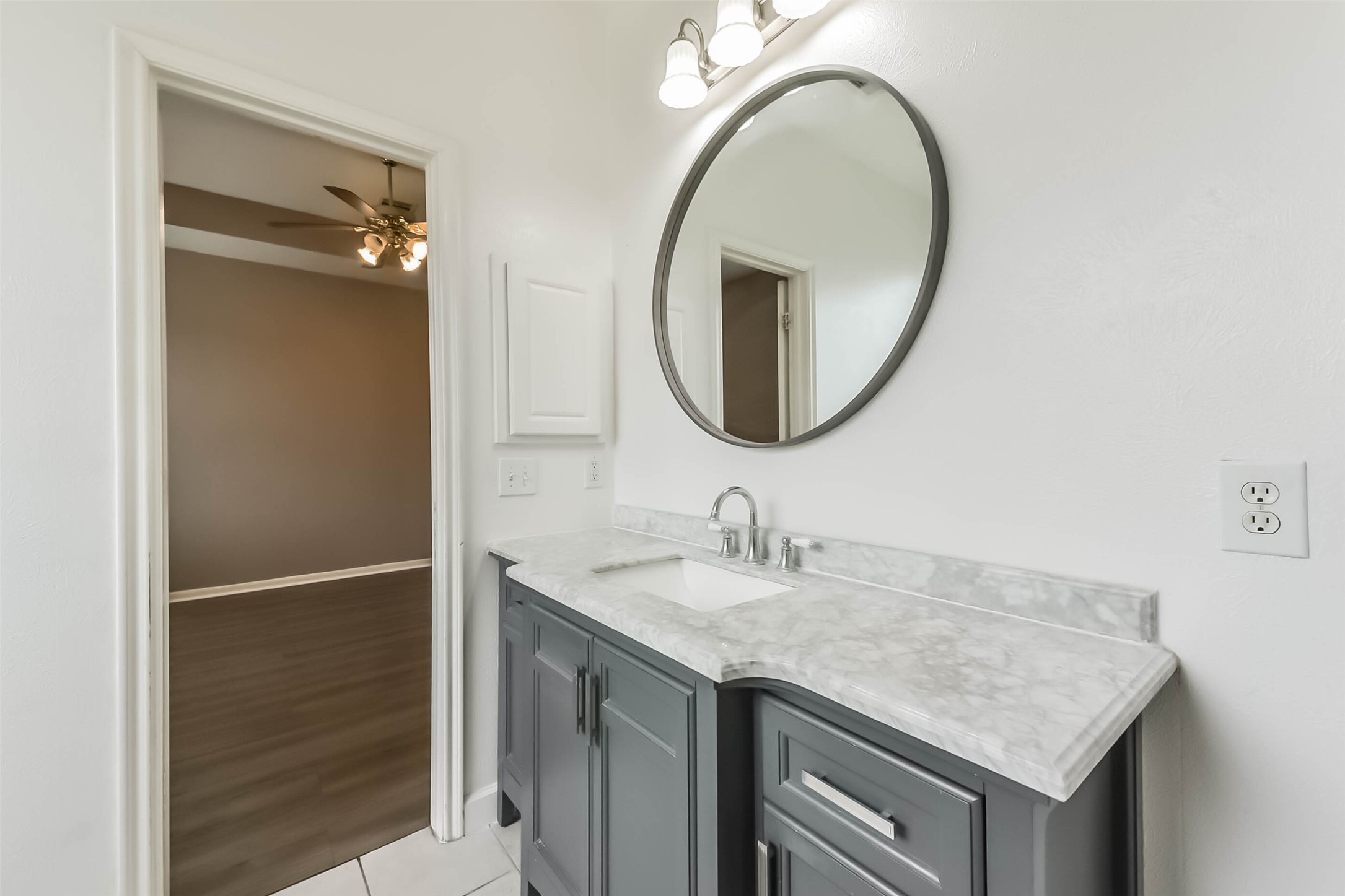 10114 Sand Tracks Court Houston, TX 77064 - Photo 28 of 49 a bathroom with a granite countertop sink and a mirror