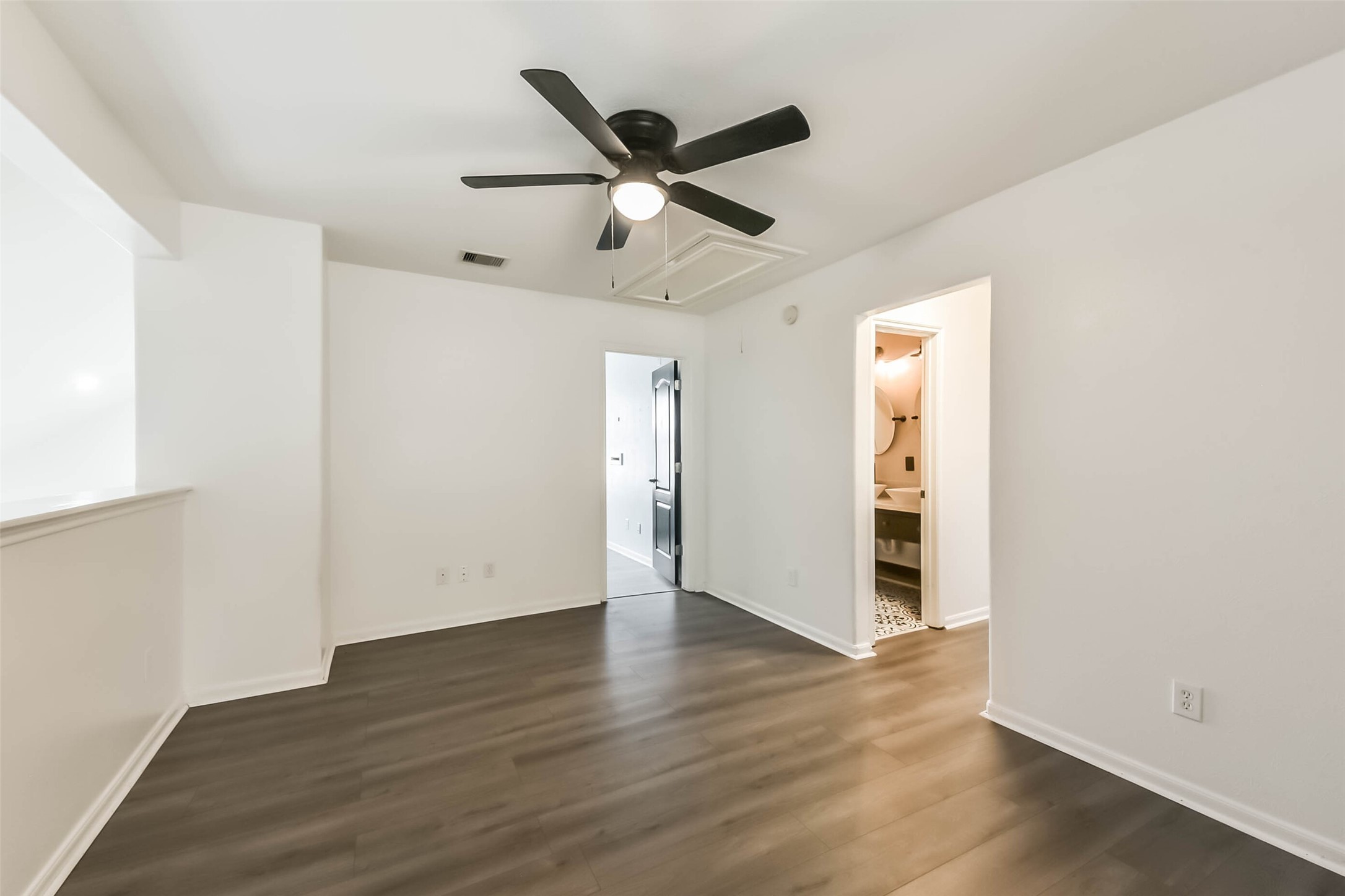 10114 Sand Tracks Court Houston, TX 77064 - Photo 31 of 49 an empty room with wooden floor a ceiling fan and a window
