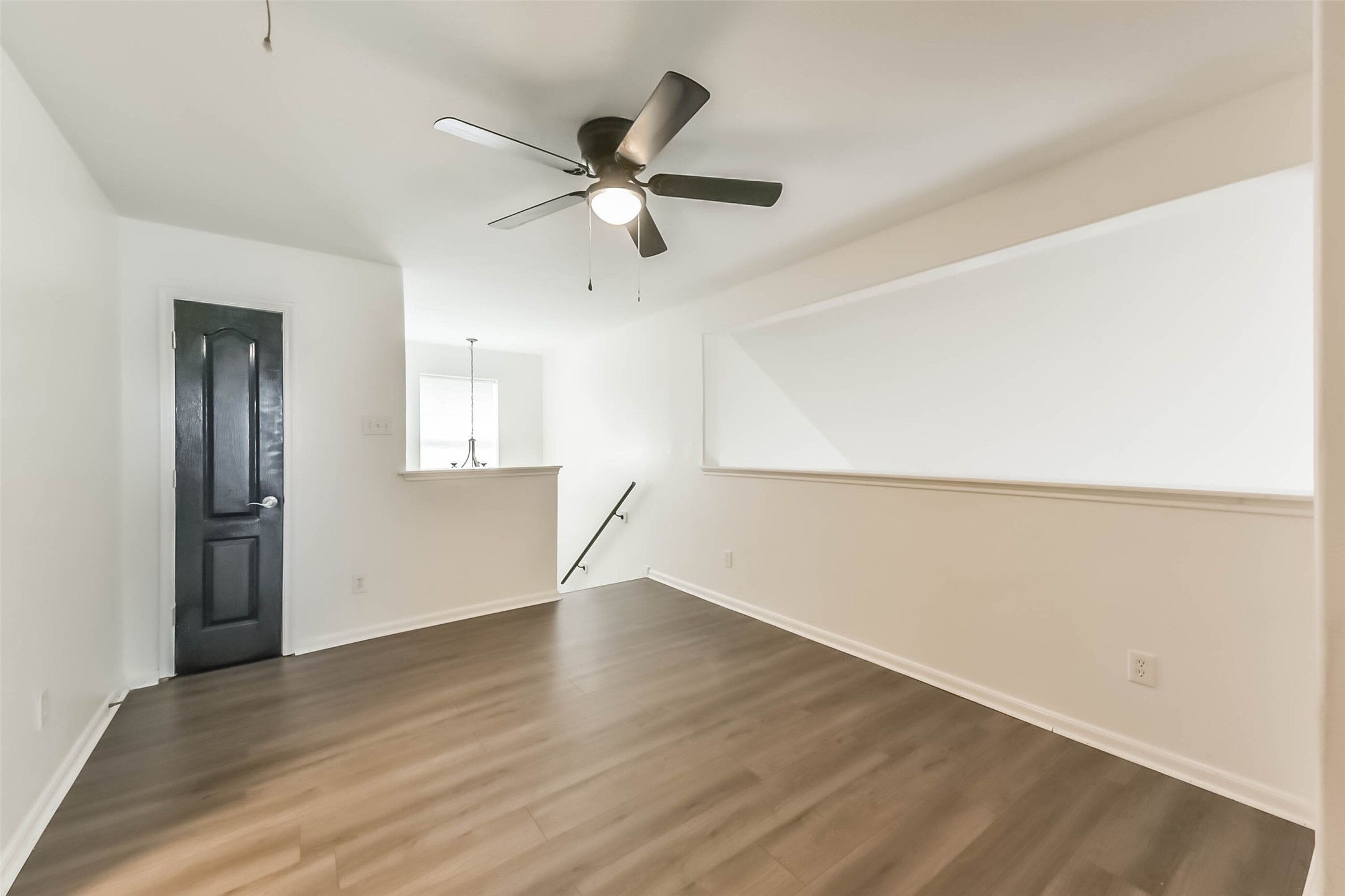 10114 Sand Tracks Court Houston, TX 77064 - Photo 32 of 49 an empty room with wooden floor closet and windows