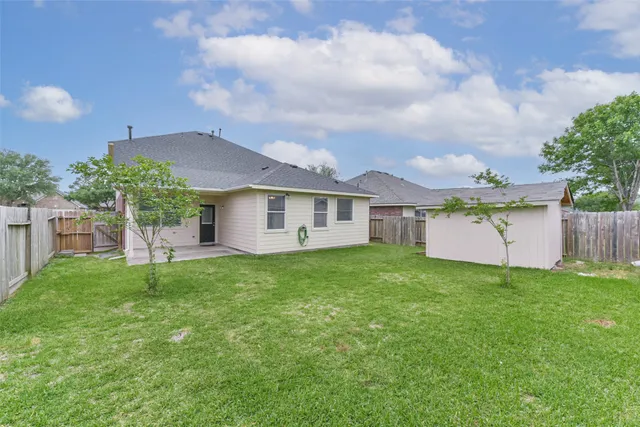 a backyard of a house with table and chairs