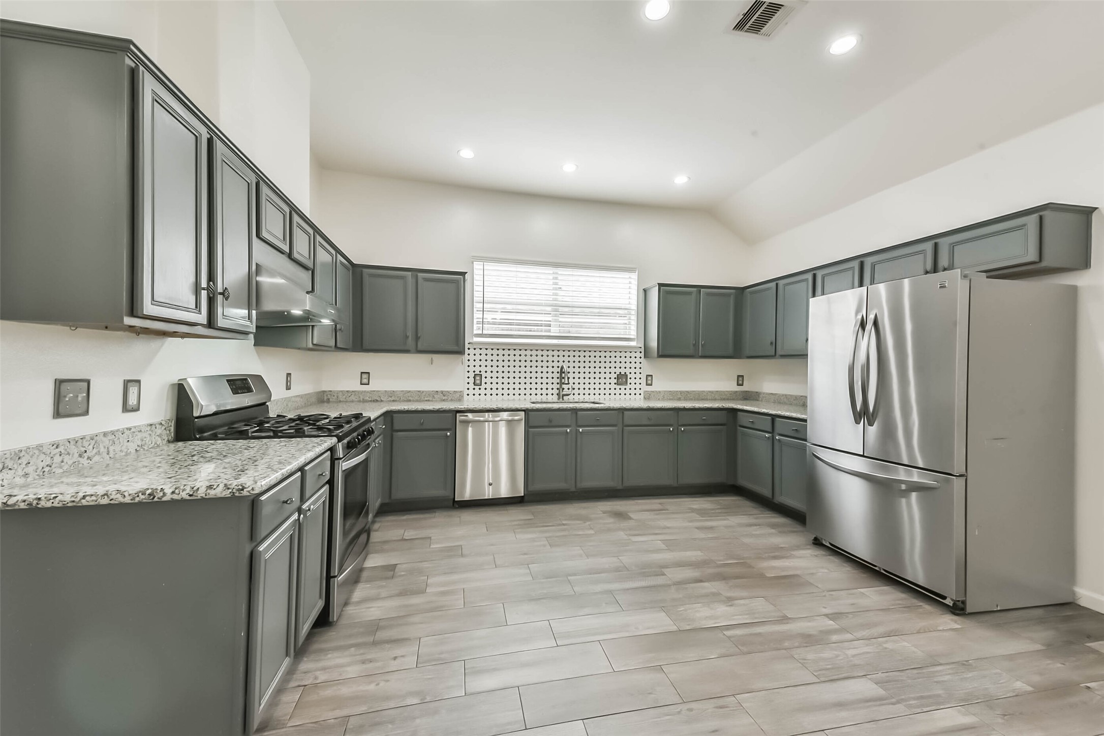 10114 Sand Tracks Court Houston, TX 77064 - Photo 4 of 49 a kitchen with stainless steel appliances granite countertop a sink a stove a refrigerator and a sink