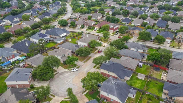 an aerial view of residential houses with outdoor space