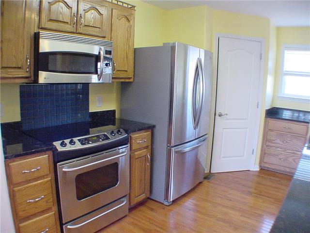 1923 Clara Mathis Road Spring Hill, TN 37174 - Photo 5 of 20 Kitchen with stainless appliances, hardwood floor and pantry storage.