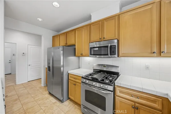 a kitchen with stainless steel appliances a refrigerator sink and cabinets