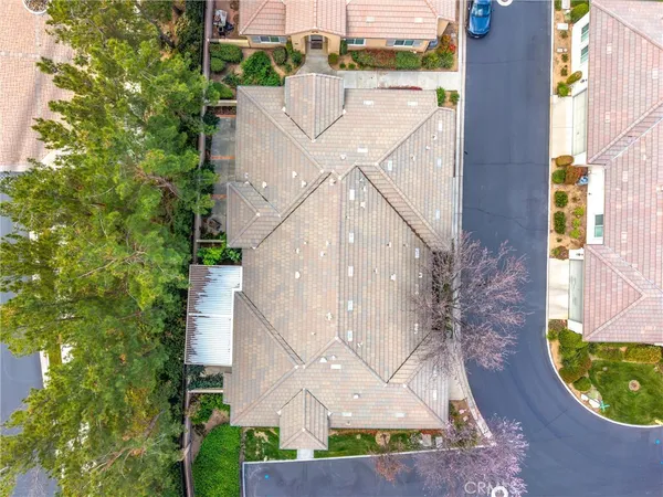 a tennis court that has trees in front of it