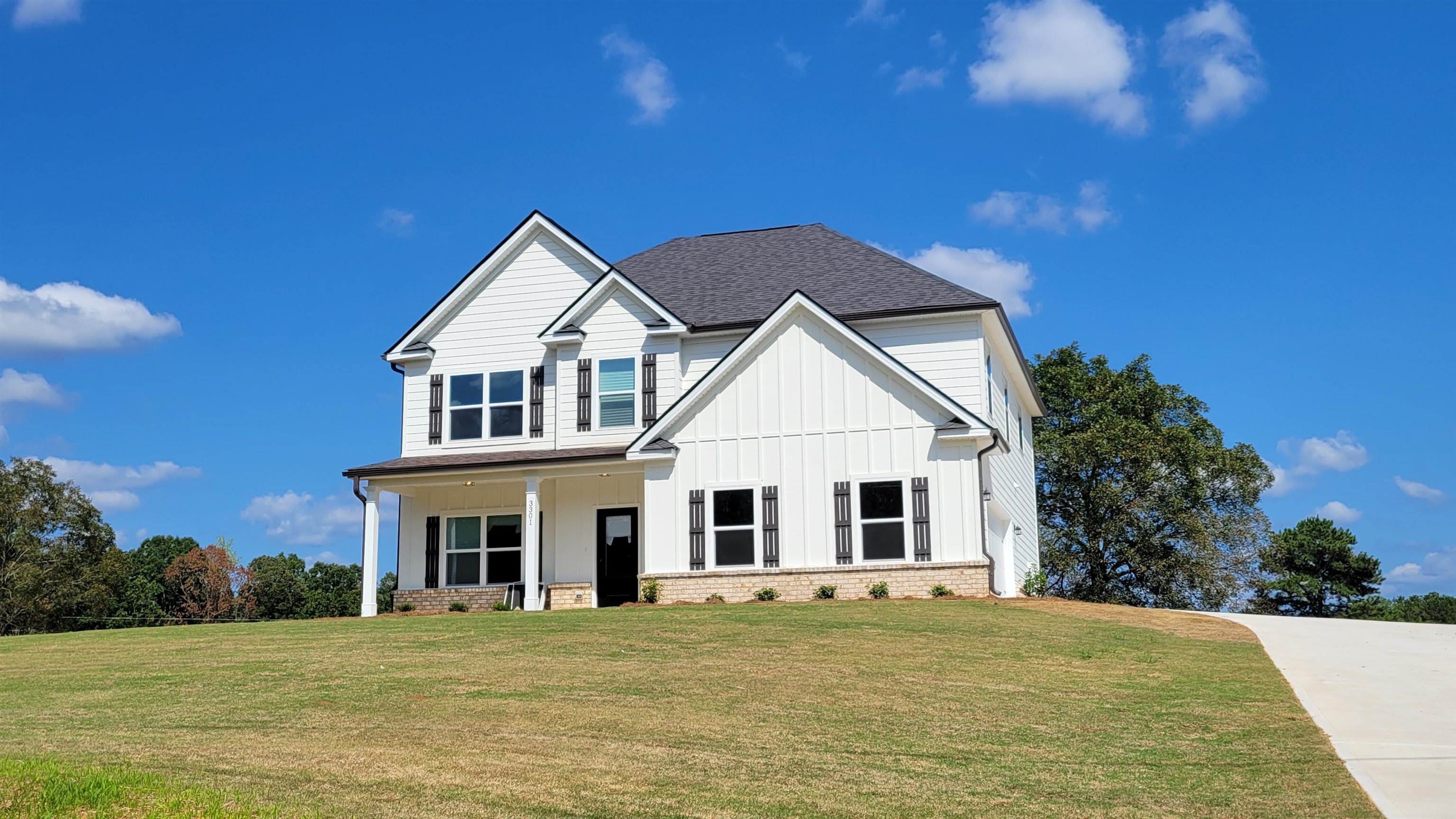 a front view of a house with a garden