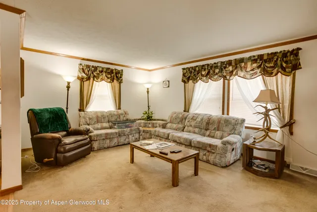 a kitchen that has a lot of cabinets a sink and a refrigerator