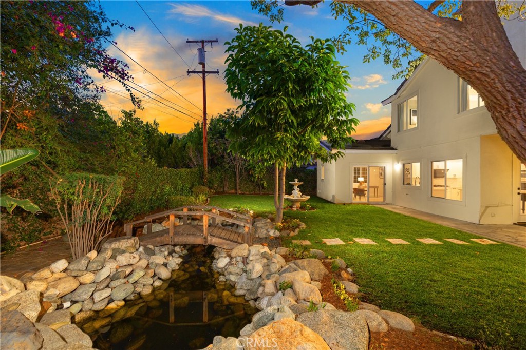 315 San Antonio Road Arcadia, CA 91007 - Photo 40 of 63 a backyard of a house with table and chairs under an umbrella