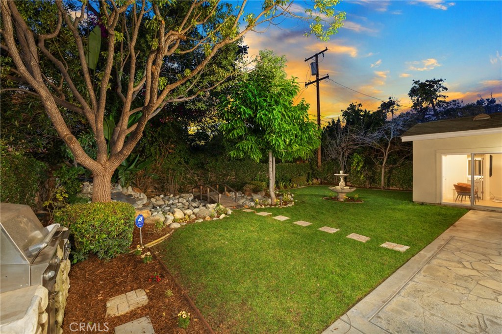315 San Antonio Road Arcadia, CA 91007 - Photo 44 of 63 a backyard of a house with table and chairs plants and large tree
