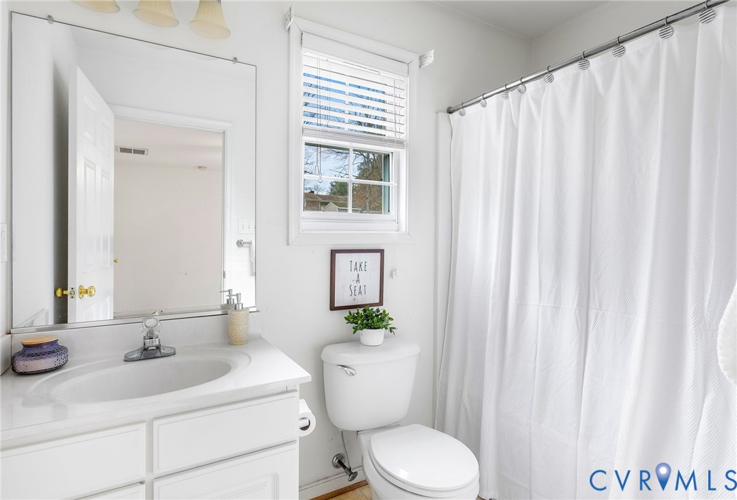 3120 Clintwood Road Midlothian, VA 23112 - Photo 21 of 38 a bathroom with a sink a toilet and a mirror
