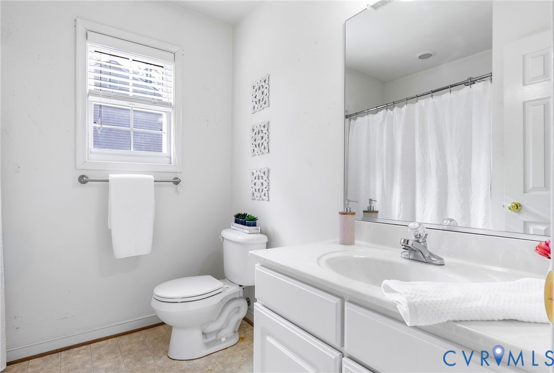 3120 Clintwood Road Midlothian, VA 23112 - Photo 24 of 38 a bathroom with a granite countertop sink toilet and mirror