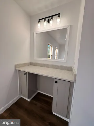 a hallway with a wooden floor and a mirror