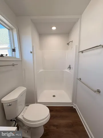 a bathroom with a toilet and a shower