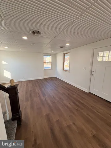 a view of a livingroom with wooden floor and window