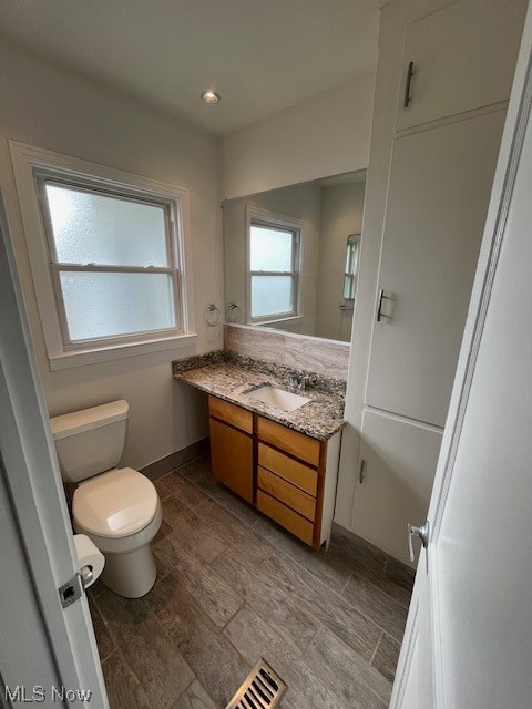 9660 Repp Road West Salem, OH 44287 - Photo 19 of 28 Bathroom featuring toilet, hardwood / wood-style floors, and oversized vanity
