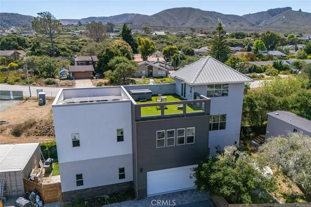 an aerial view of a house with a yard