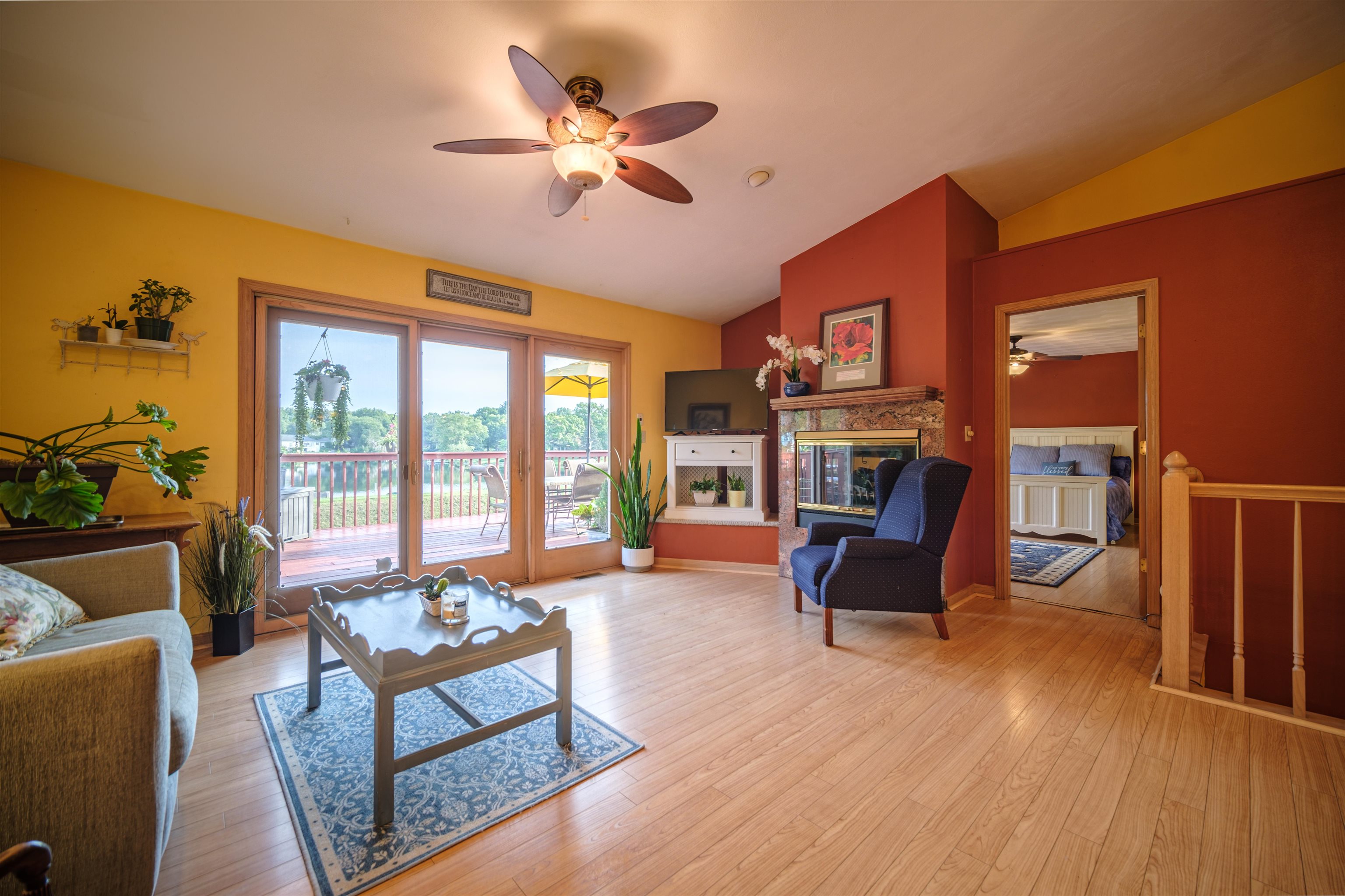 5592 Spring Brook Road Rockford, IL 61114 - Photo 25 of 53 a living room with furniture a flat screen tv and floor to ceiling window