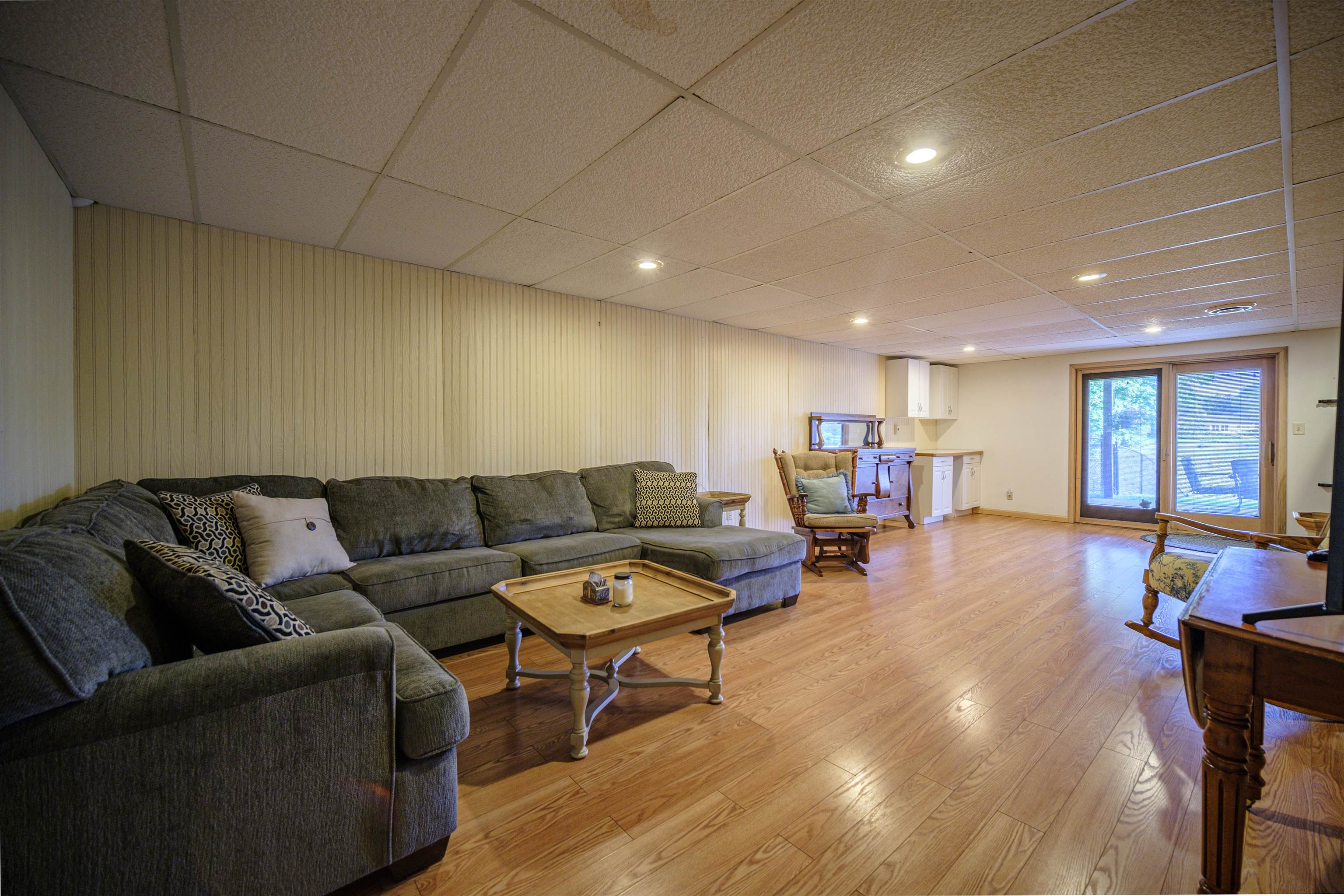5592 Spring Brook Road Rockford, IL 61114 - Photo 29 of 53 a living room with furniture and a wooden floor