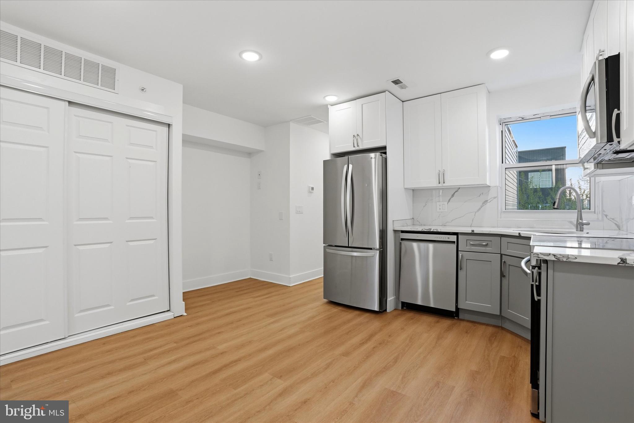 2104 North 8th Street, Unit 3 Philadelphia, PA 19122 - Photo 5 of 15 a kitchen with a refrigerator and a sink