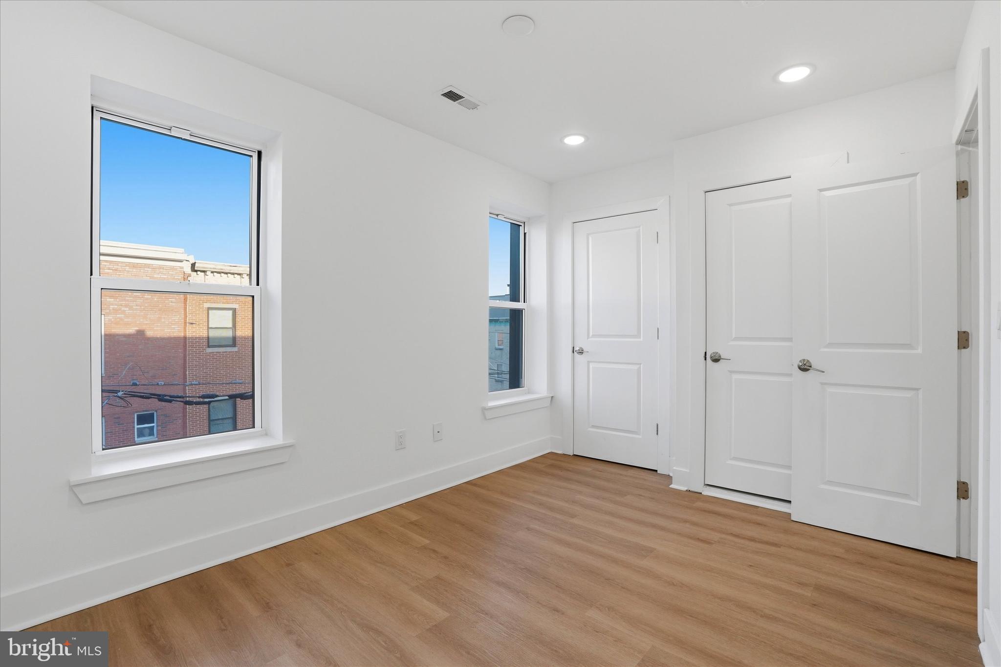 2104 North 8th Street, Unit 3 Philadelphia, PA 19122 - Photo 9 of 15 a view of empty room with wooden floor and fan