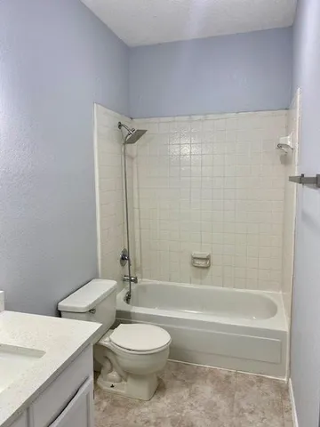 a bathroom with a toilet a sink and bathtub