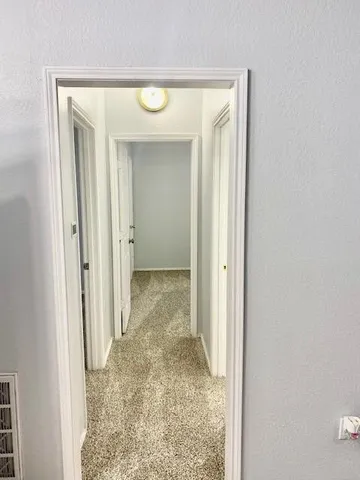 a view of a bathroom with a glass door and a window