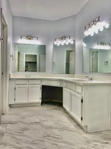 a bathroom with a sink vanity and a mirror