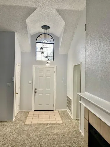 an empty room with mirror and entrance