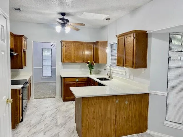 a kitchen with stainless steel appliances granite countertop a sink refrigerator and cabinets