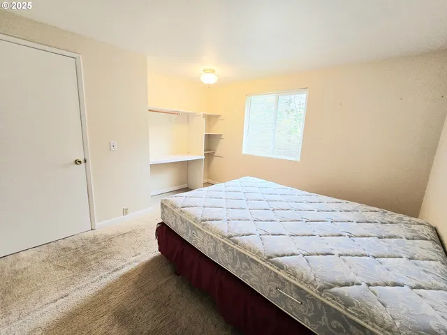 a bedroom with a bed and window