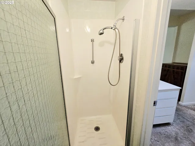 a bathroom with a glass shower door