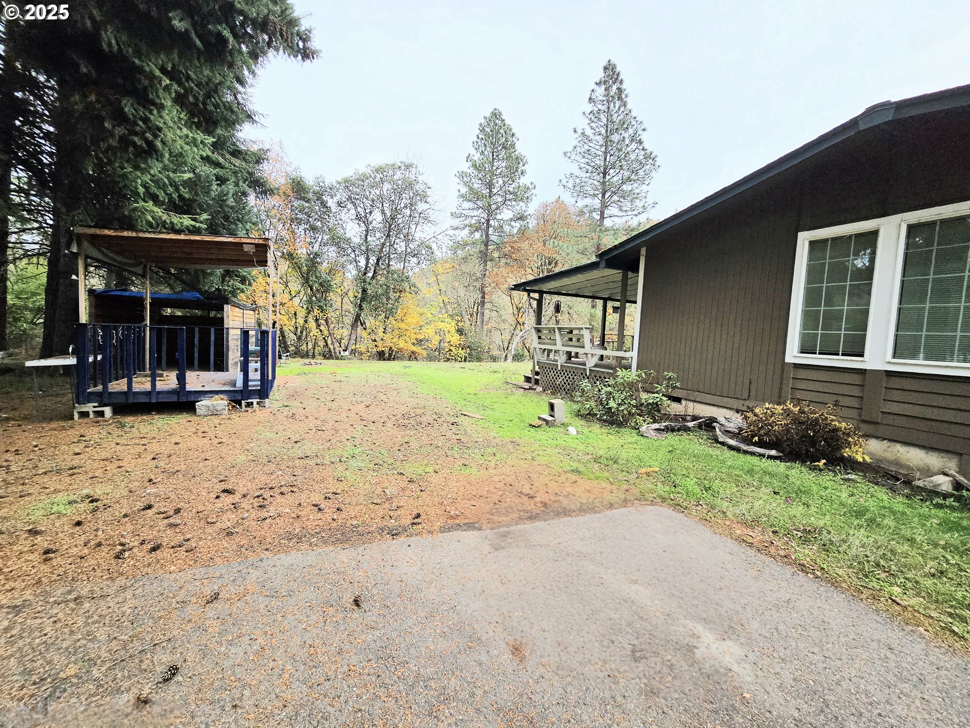 239 Arrow Way Myrtle Creek, OR 97457 - Photo 23 of 25 a backyard of a house with barbeque oven and outdoor seating