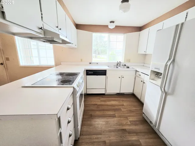 a kitchen with a stove a sink and a refrigerator