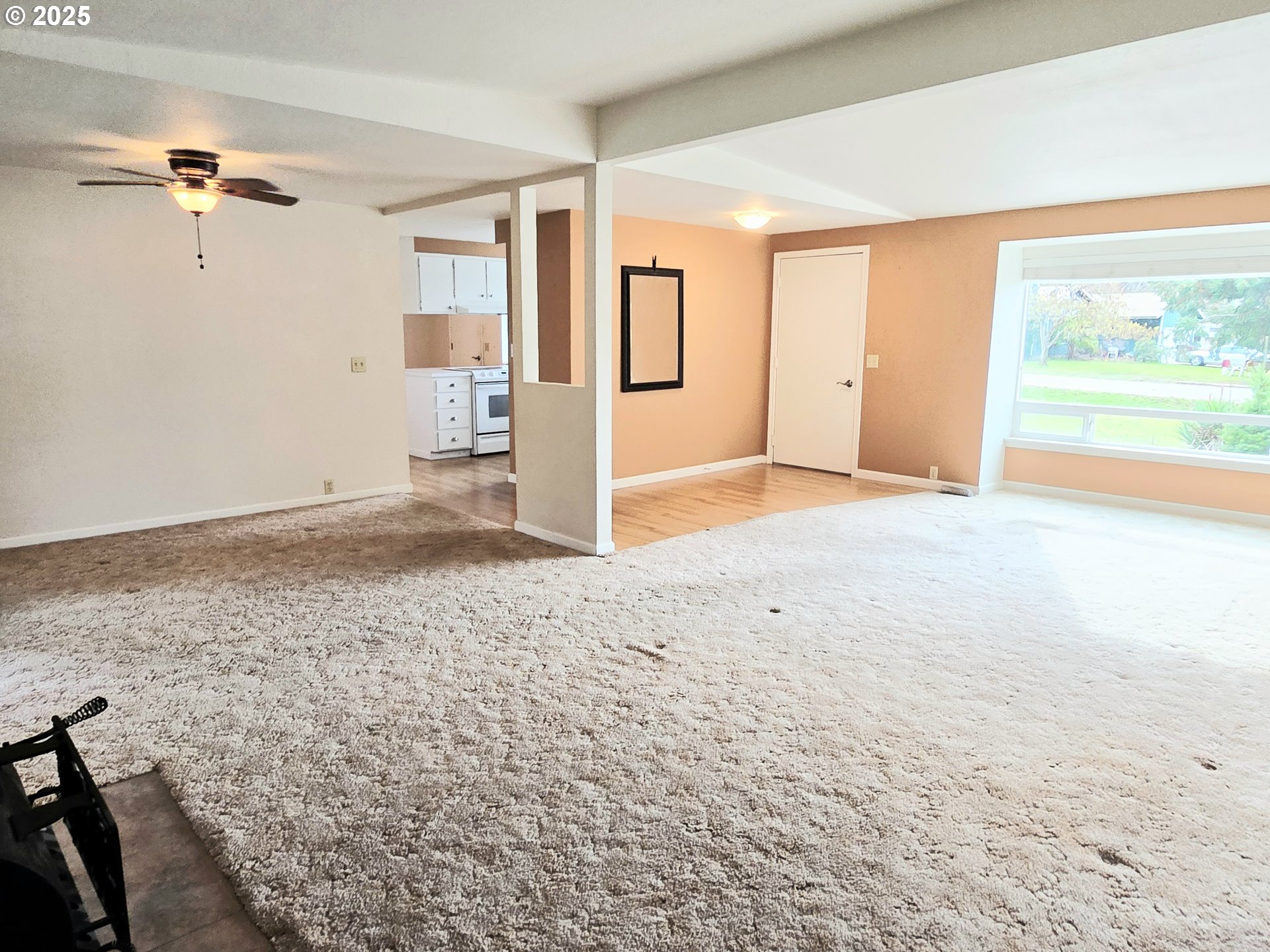 239 Arrow Way Myrtle Creek, OR 97457 - Photo 8 of 25 a view of a livingroom with wooden floor and a ceiling fan