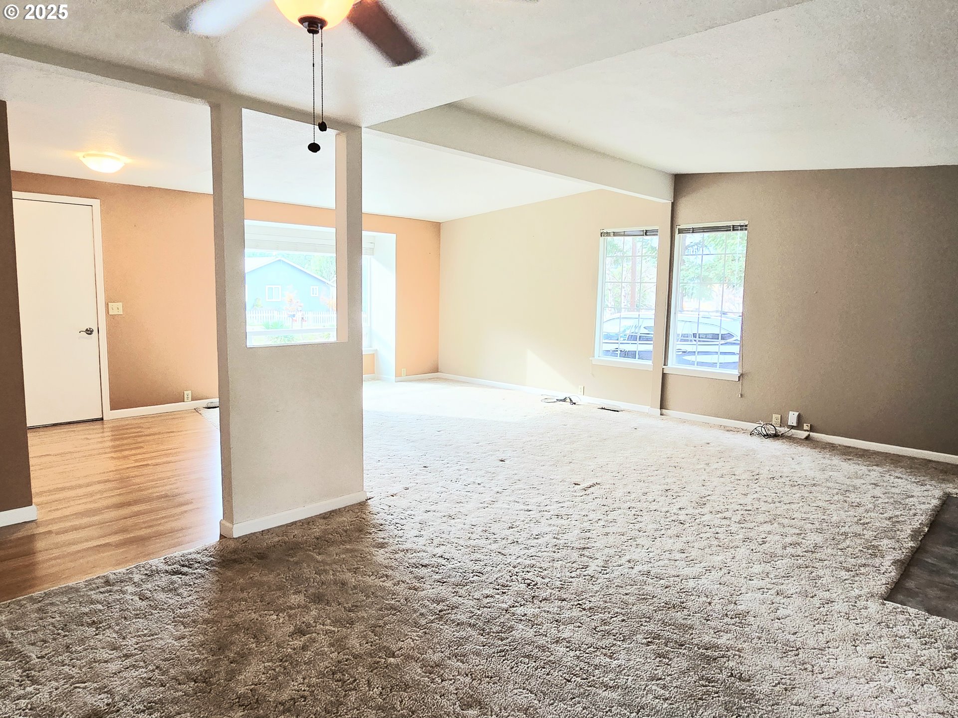239 Arrow Way Myrtle Creek, OR 97457 - Photo 10 of 25 an empty room with chandelier fan and windows