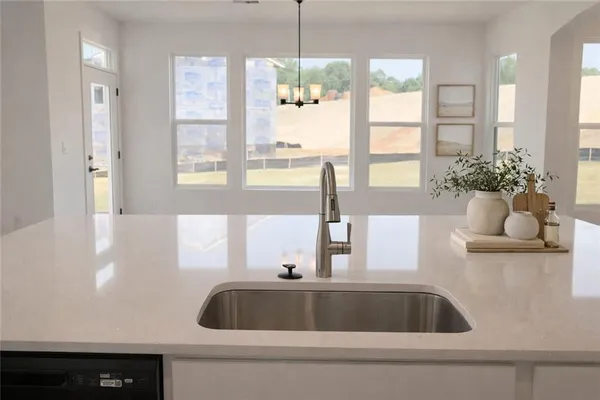 a kitchen with a sink and a large window