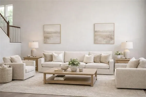 a living room with furniture and a potted plant on a coffee table