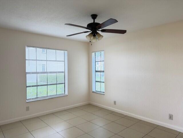 2950 Olivewood Terrace, Unit 1120 Boca Raton, FL 33431 - Photo 3 of 12 an empty room with windows and fan