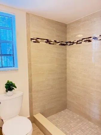 a bathroom with a shower a toilet and a sink