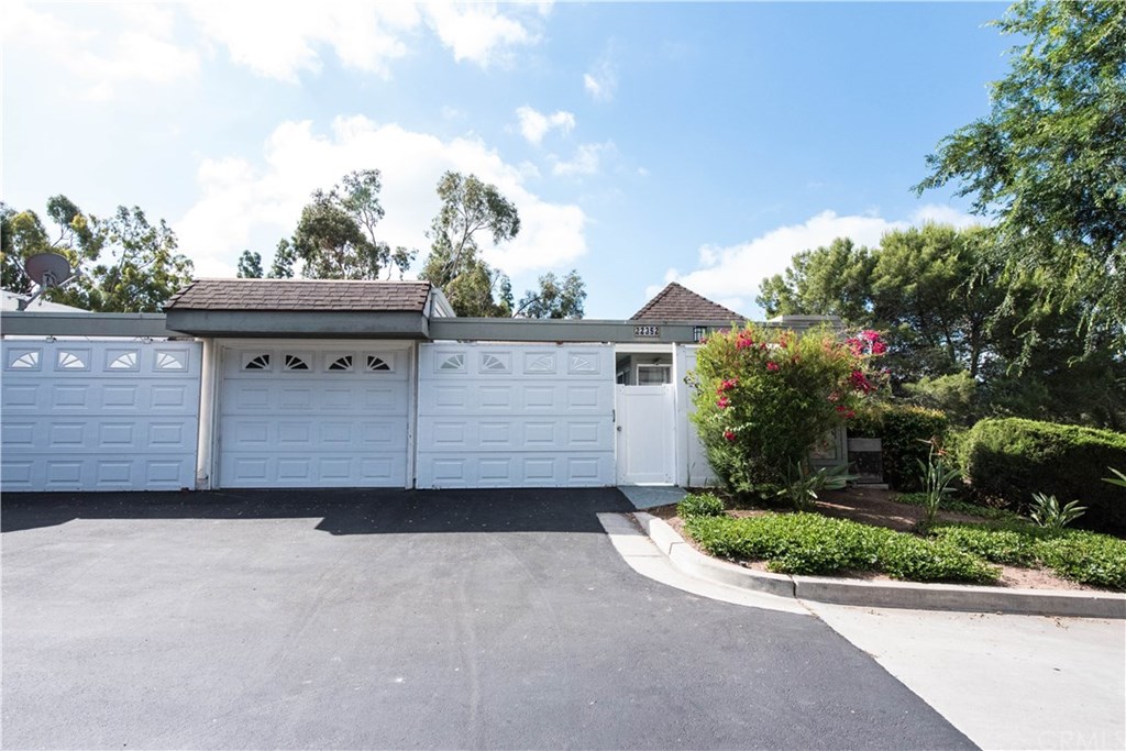 Welcome Home!  Front view of this upgraded 3 bedroom, 2.25 bathroom Monterey Model end unit.  Guest parking lot is to the right of the unit beyond the bushes and tress.