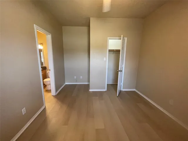 an empty room with closet and mirror