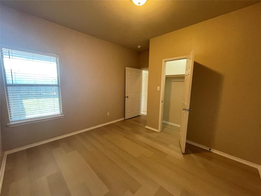 101 Sunburst Court, Unit 107 Weatherford, TX 76087 - Photo 16 of 24 a view of an empty room with a window