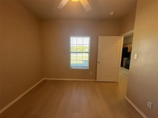 an empty room with windows and closet