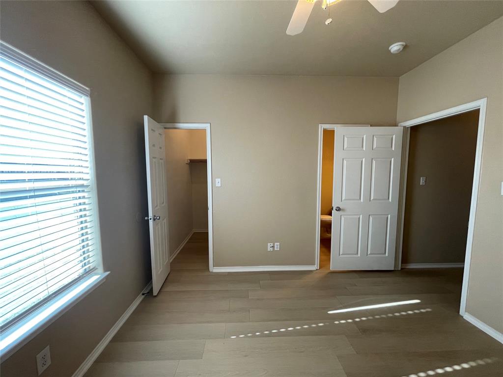 101 Sunburst Court, Unit 107 Weatherford, TX 76087 - Photo 18 of 24 an empty room with windows and closet