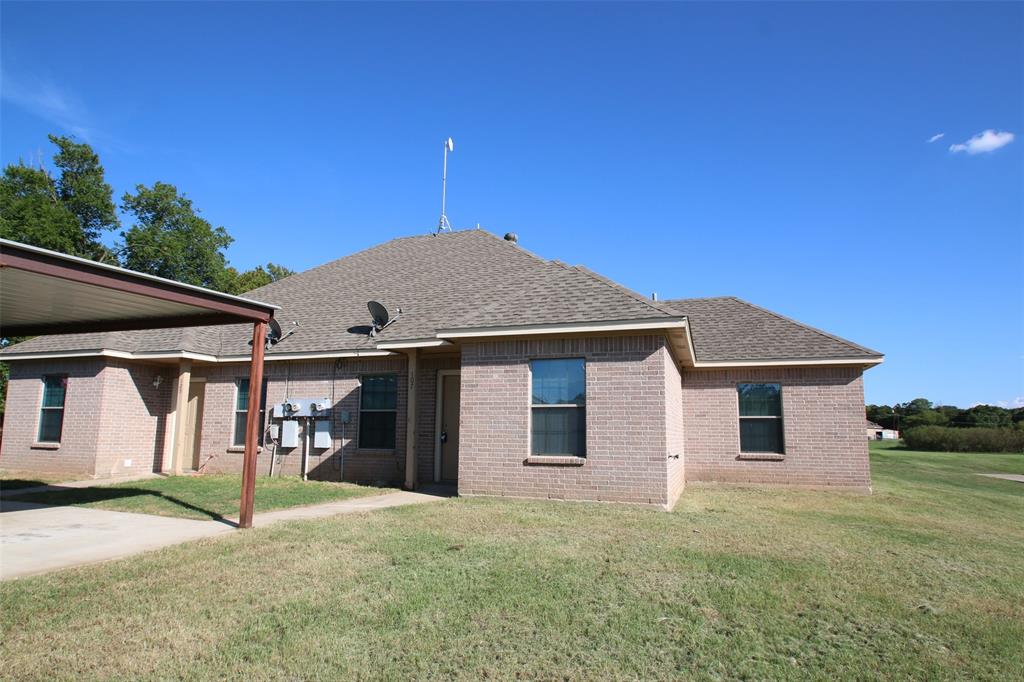 101 Sunburst Court, Unit 107 Weatherford, TX 76087 - Photo 2 of 24 a front view of a house with garden