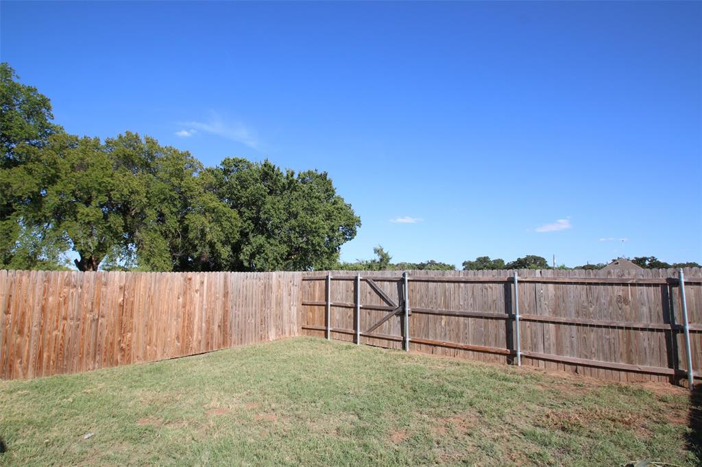 101 Sunburst Court, Unit 107 Weatherford, TX 76087 - Photo 21 of 24 a view of a backyard