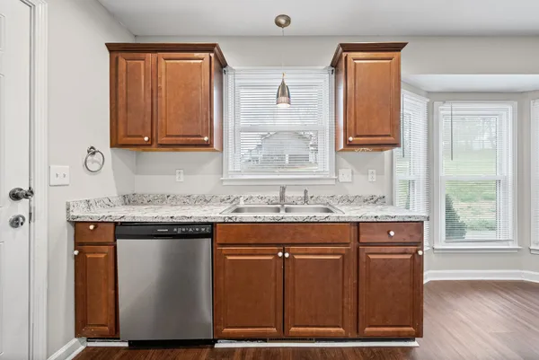 a kitchen with granite countertop a sink and a stove