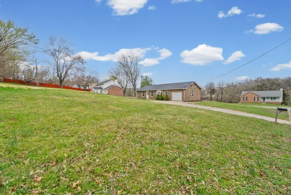 a house view with swimming pool in front of it